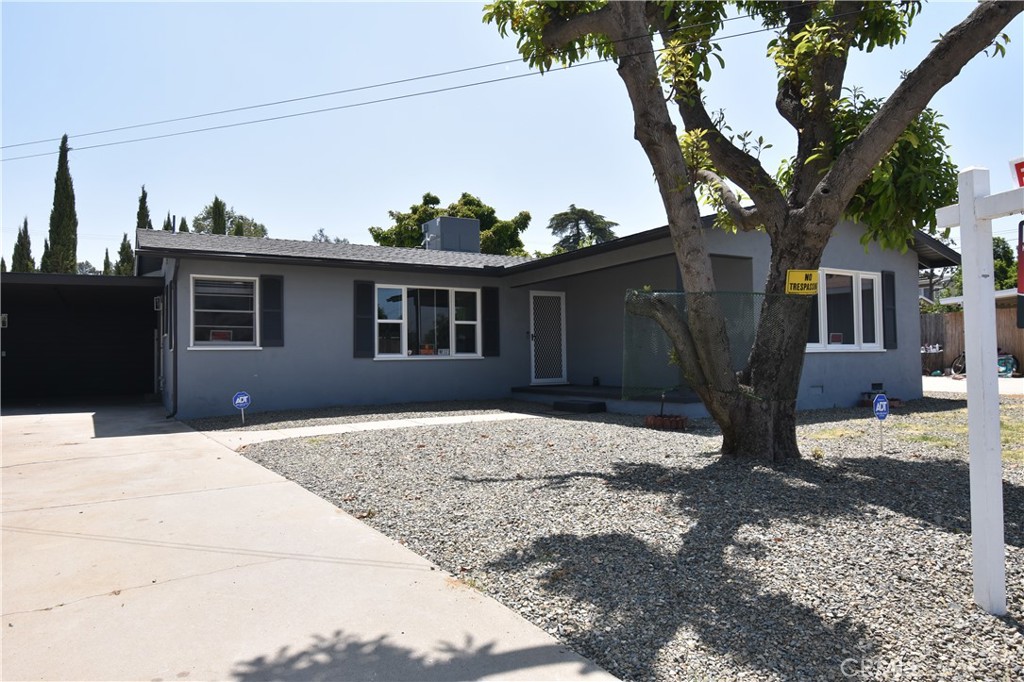 a view of a house with a tree in the background