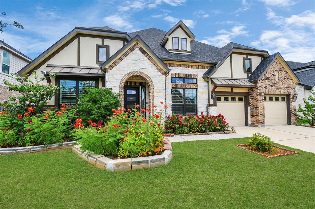 a front view of a house with a garden