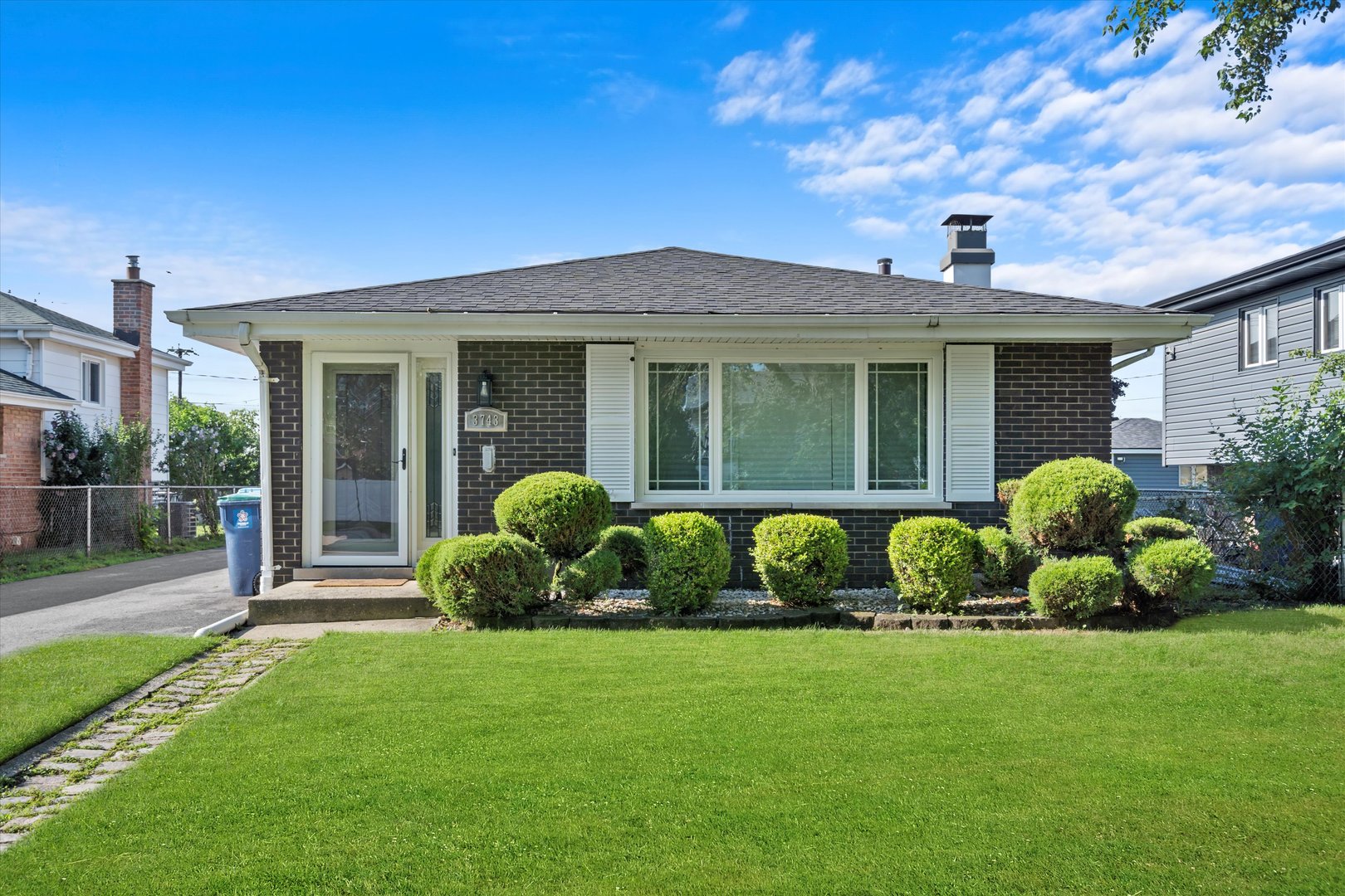 a front view of a house with a garden