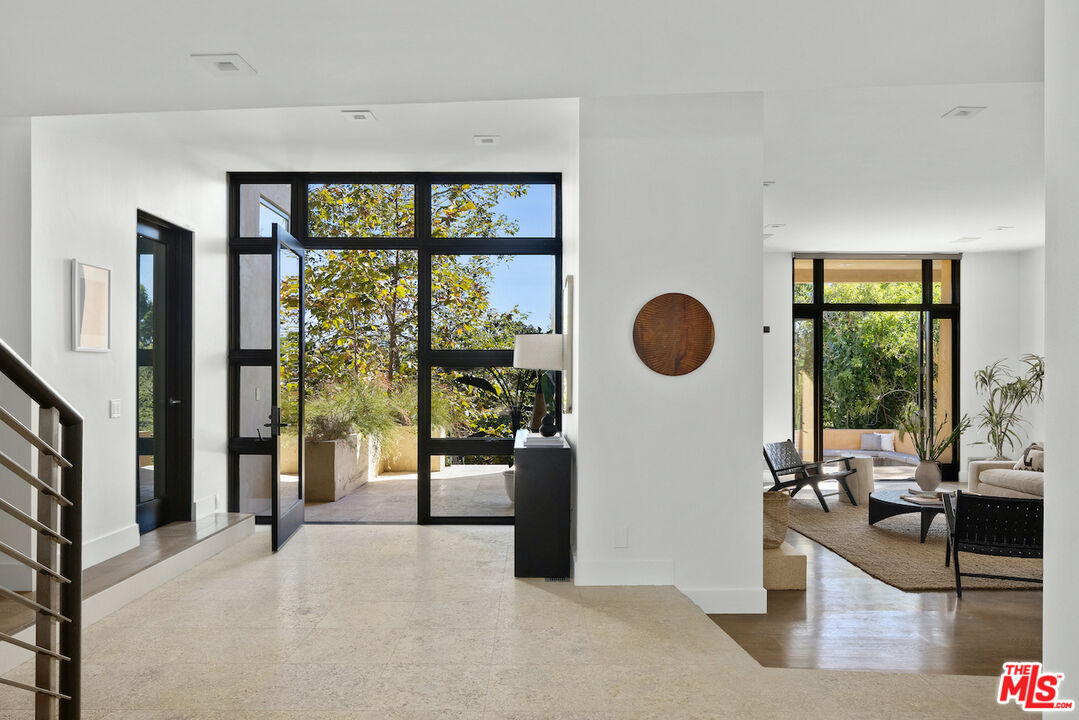 a view of a living room and floor to ceiling window or kitchen