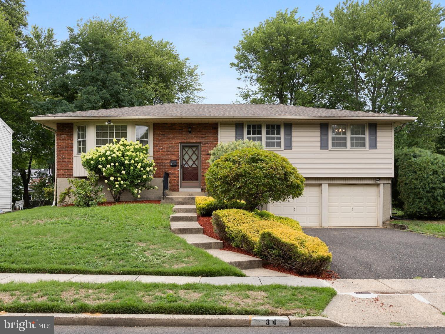 a front view of a house with a yard and potted plants