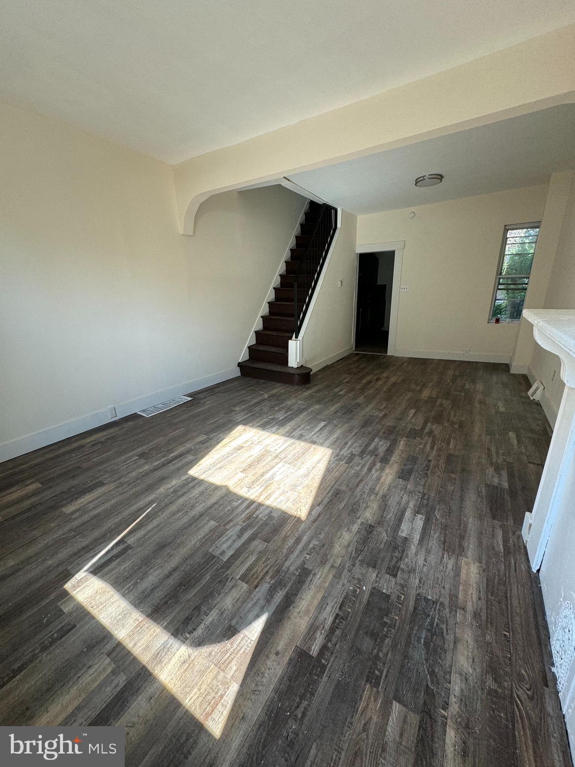 a view of an empty room and wooden floor