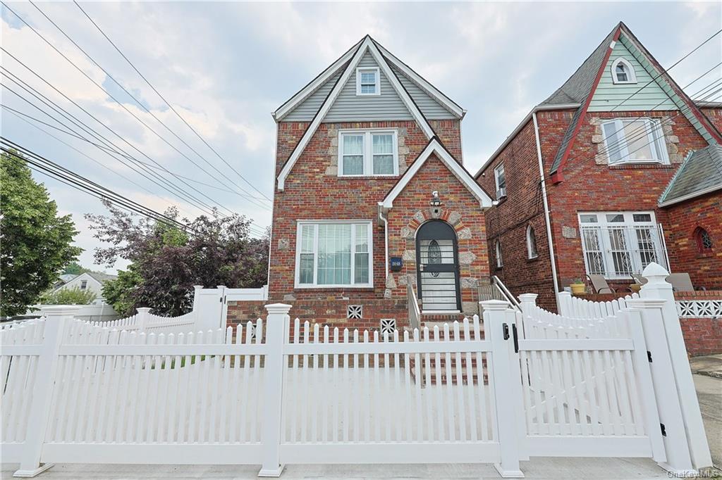 a front view of a house with a fence