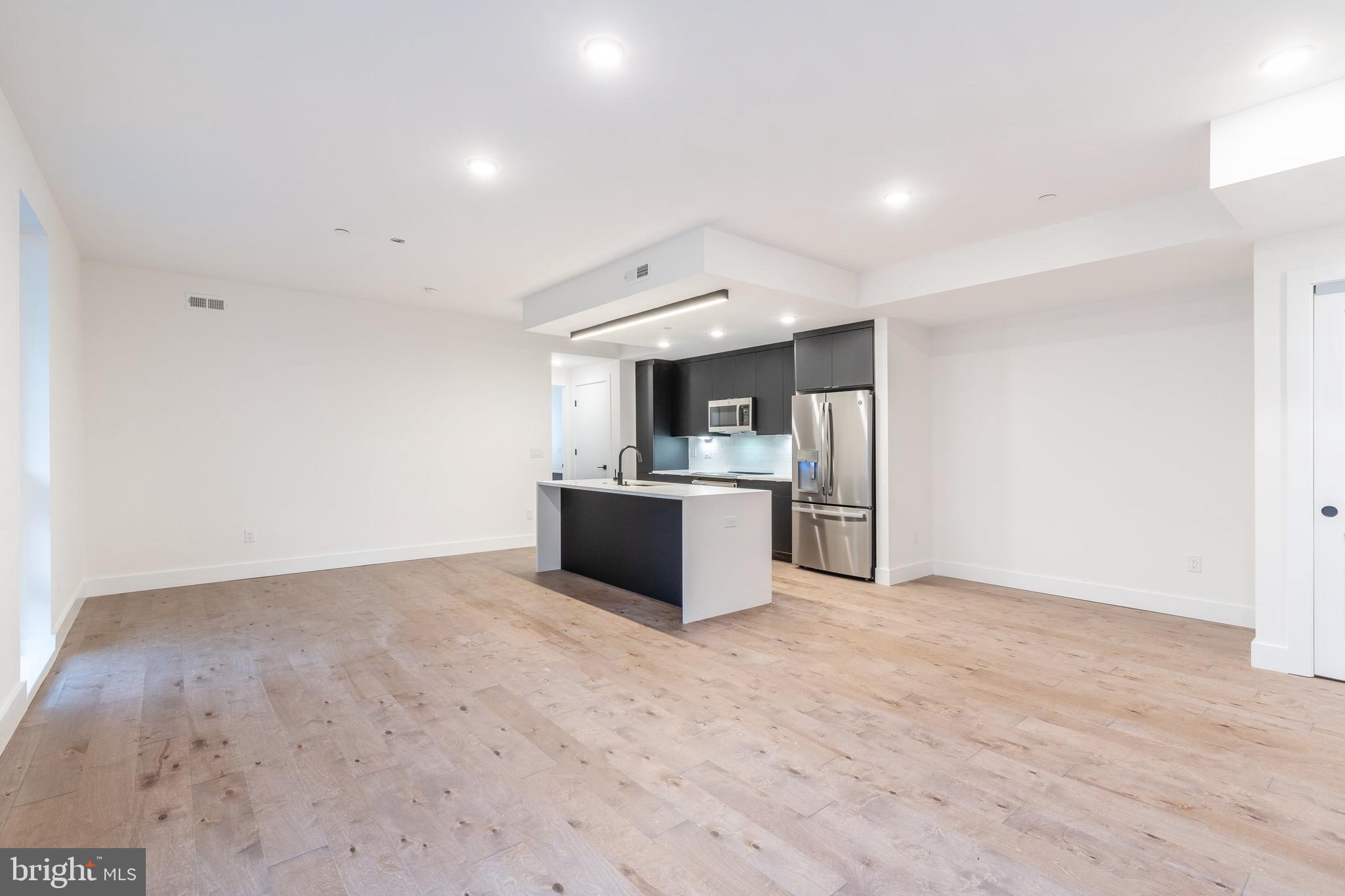 a view of kitchen and refrigerator