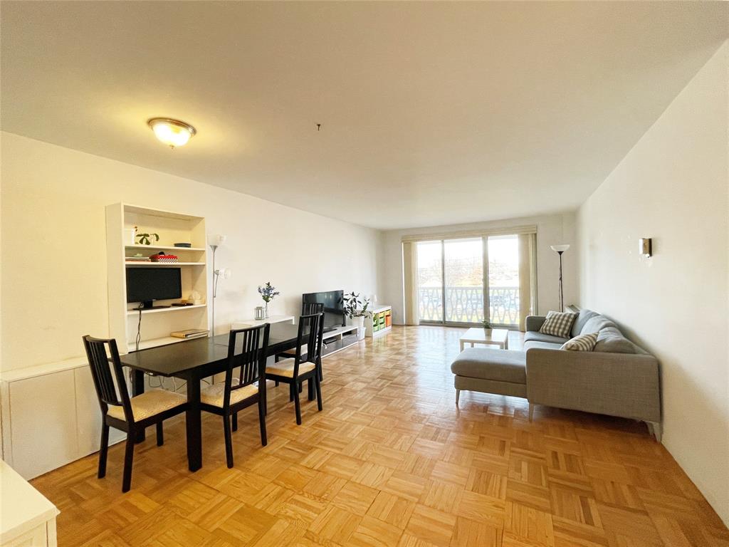 a living room with fireplace furniture and a large window