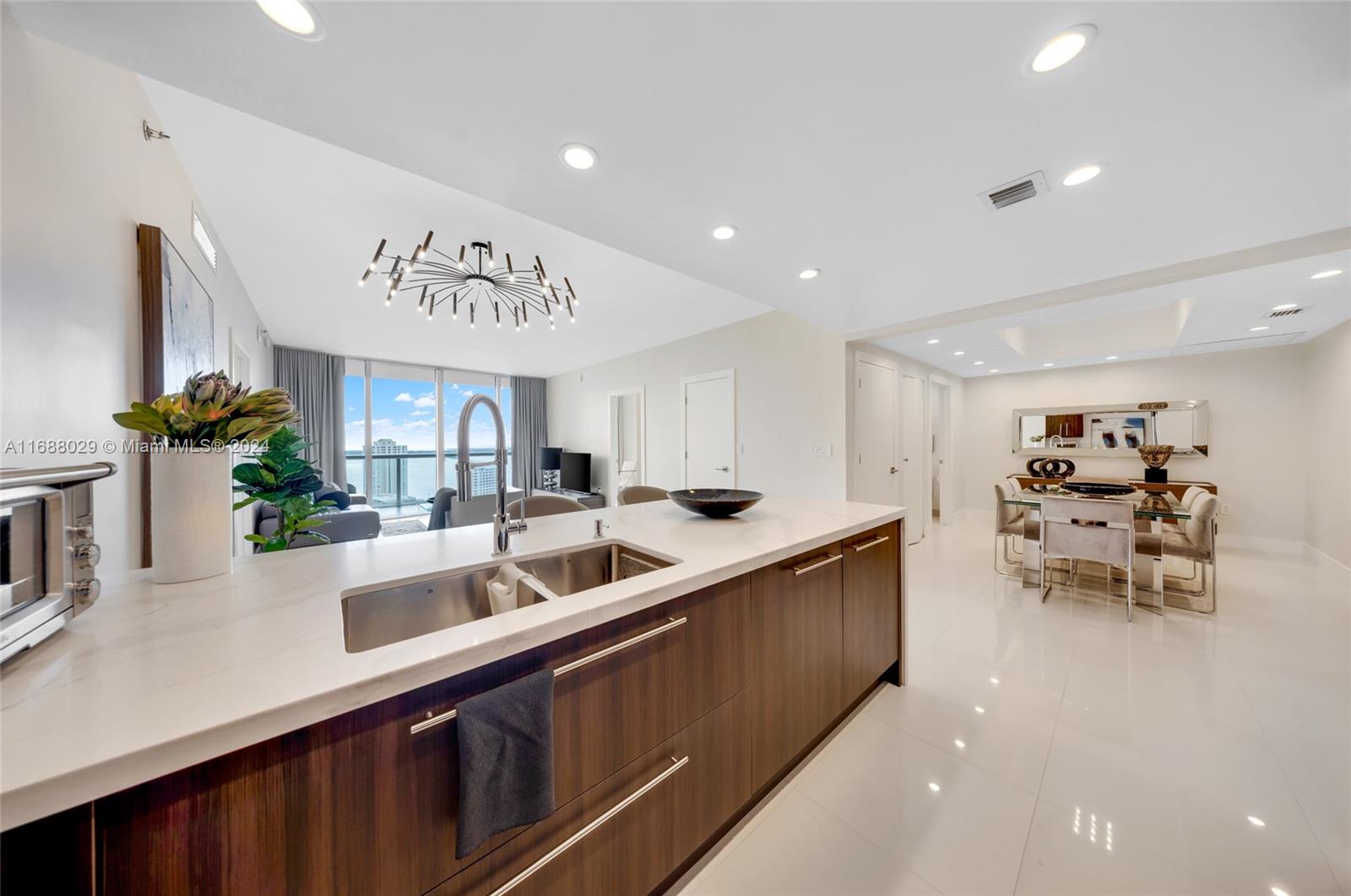 a kitchen with stainless steel appliances a sink and a refrigerator