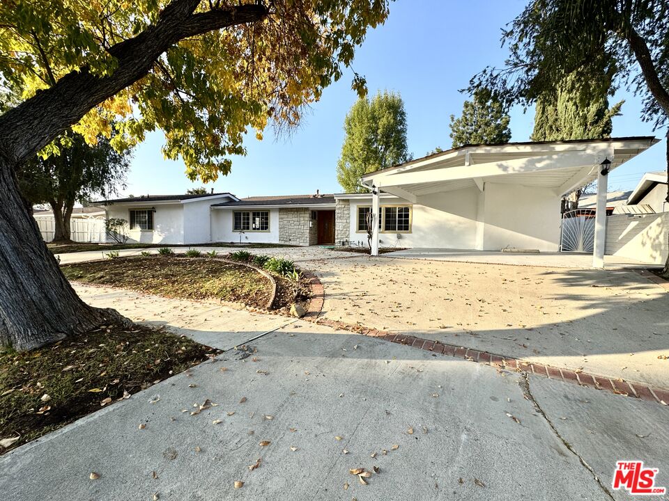 a view of a house with a tree in a yard