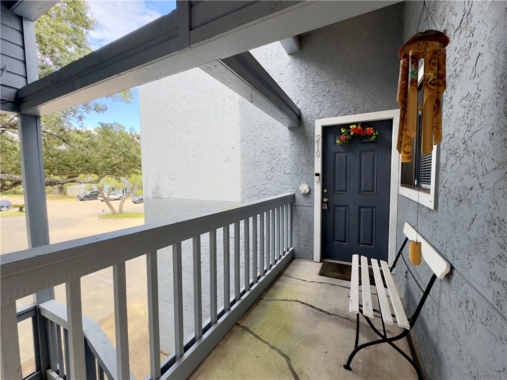 a view of a porch with wooden floor