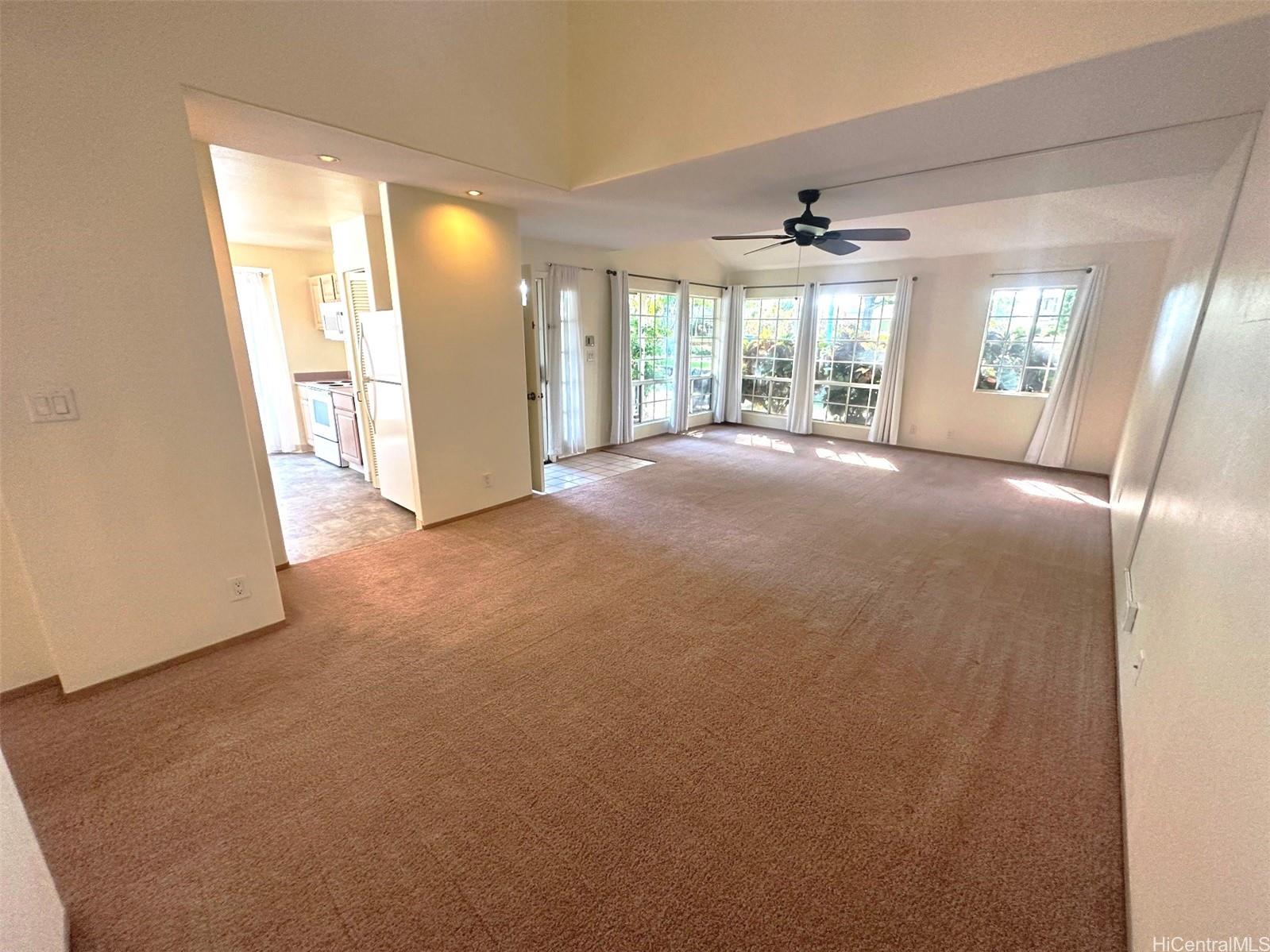 a view of an empty room with a fireplace and a large window