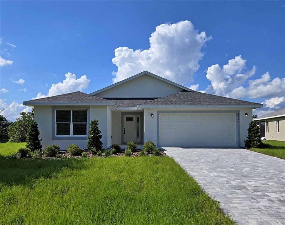 a front view of a house with garden