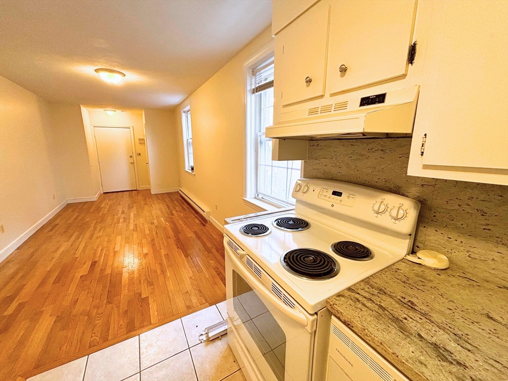 a kitchen with a stove and a white refrigerator