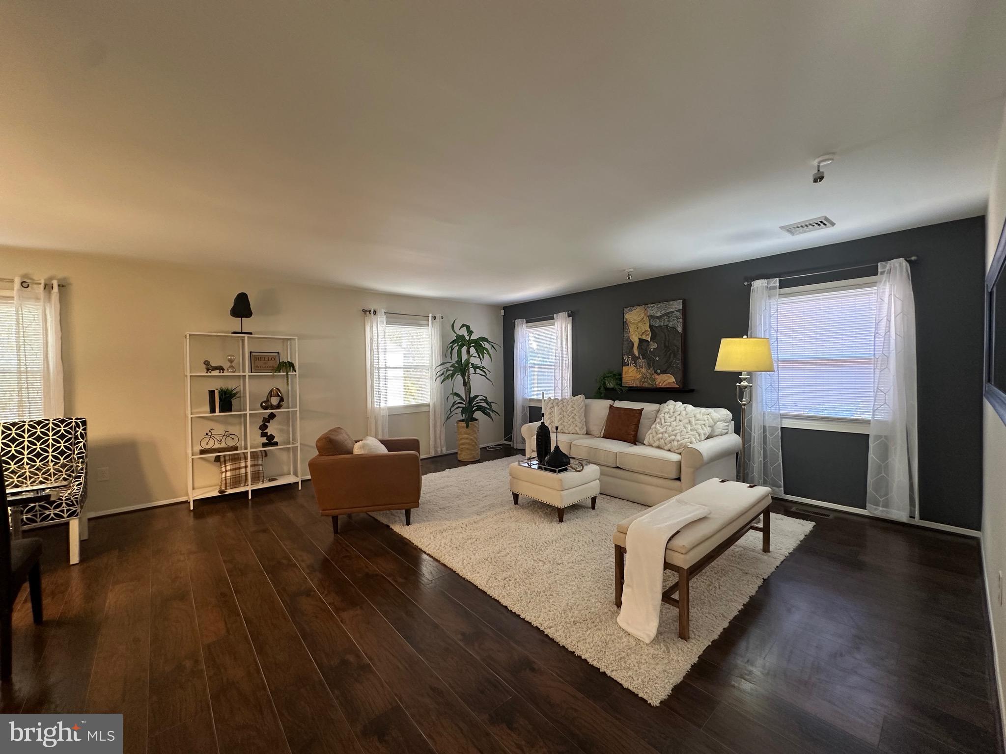 a living room with furniture window and wooden floor