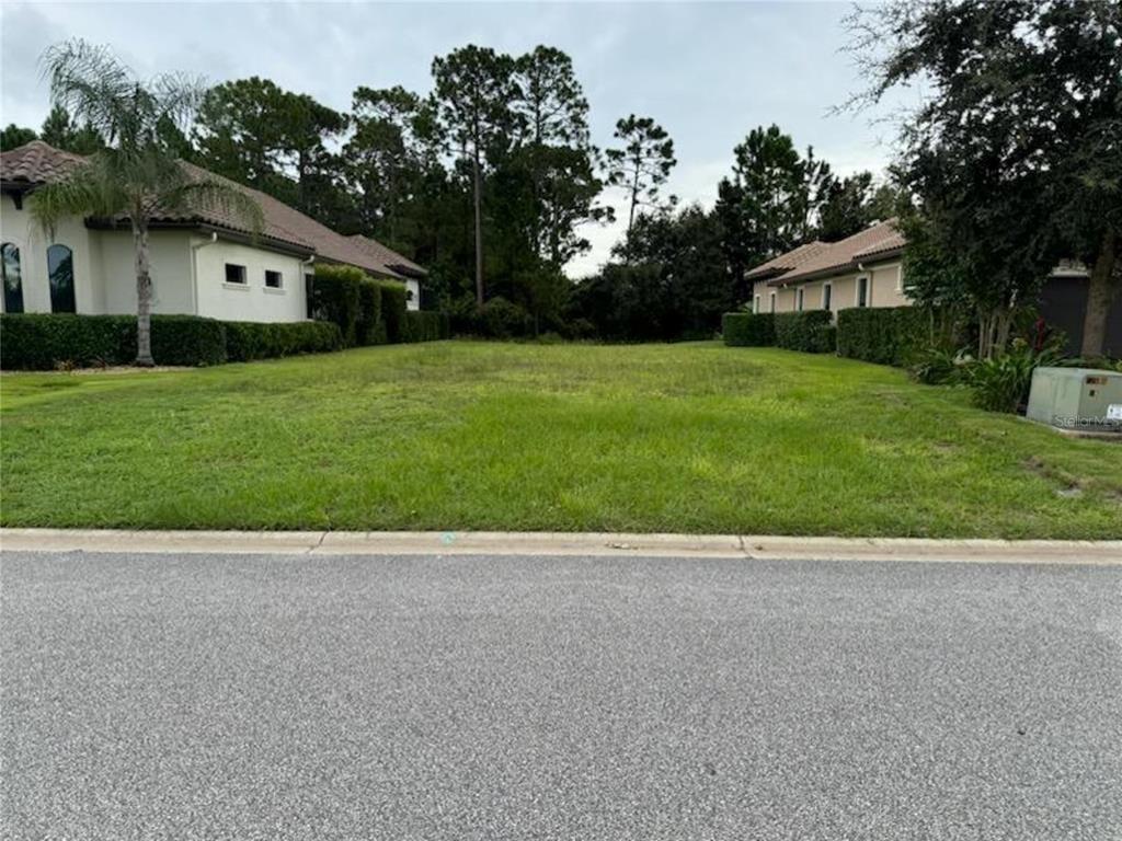 a view of house with backyard