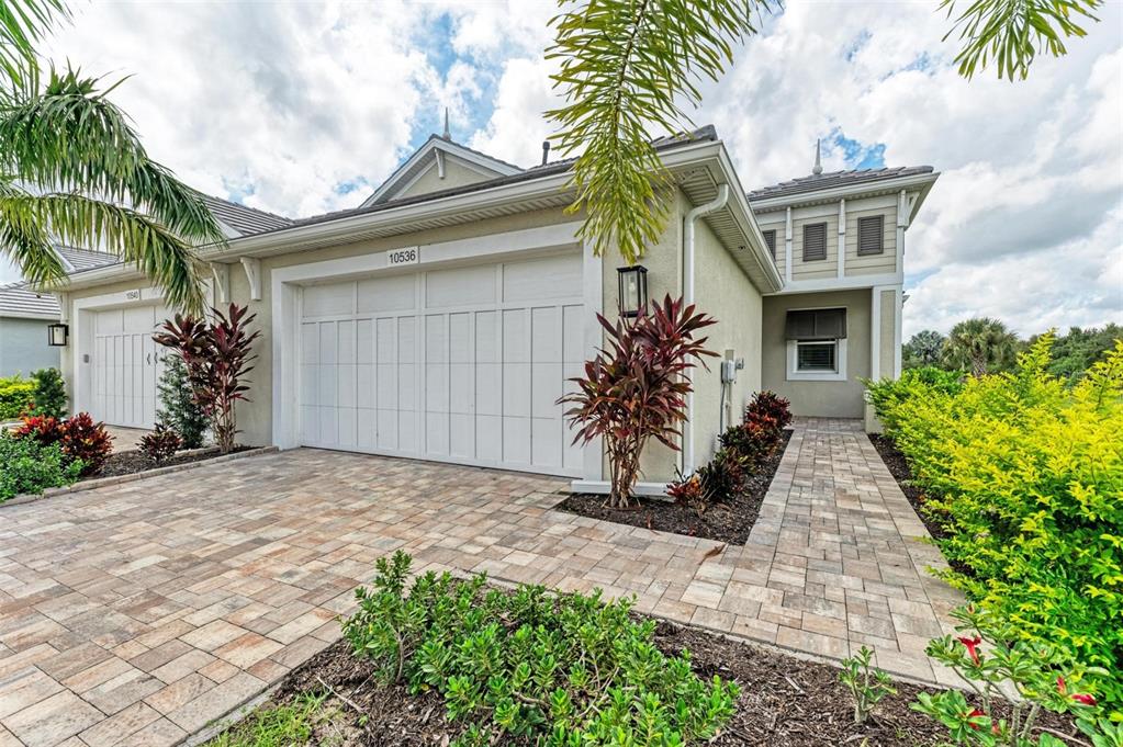 a front view of a house with a yard and a garage