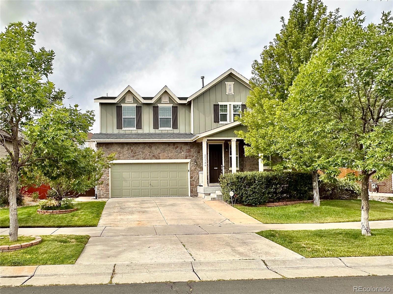 a front view of a house with a yard and garage