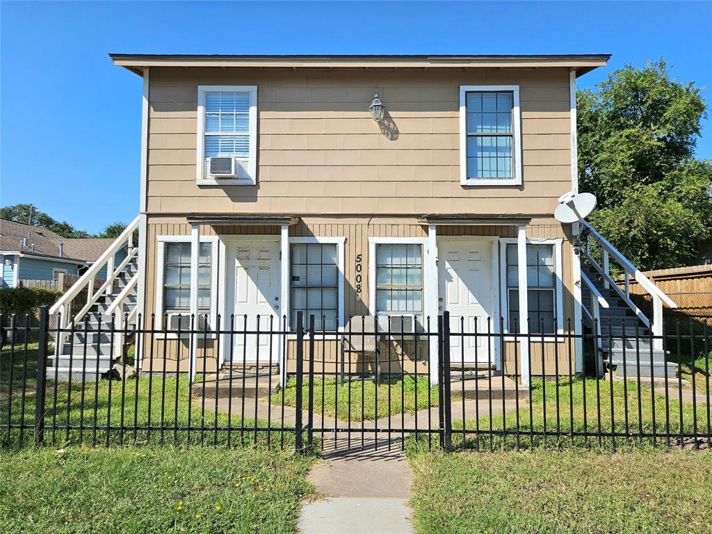 a view of a house with a fence