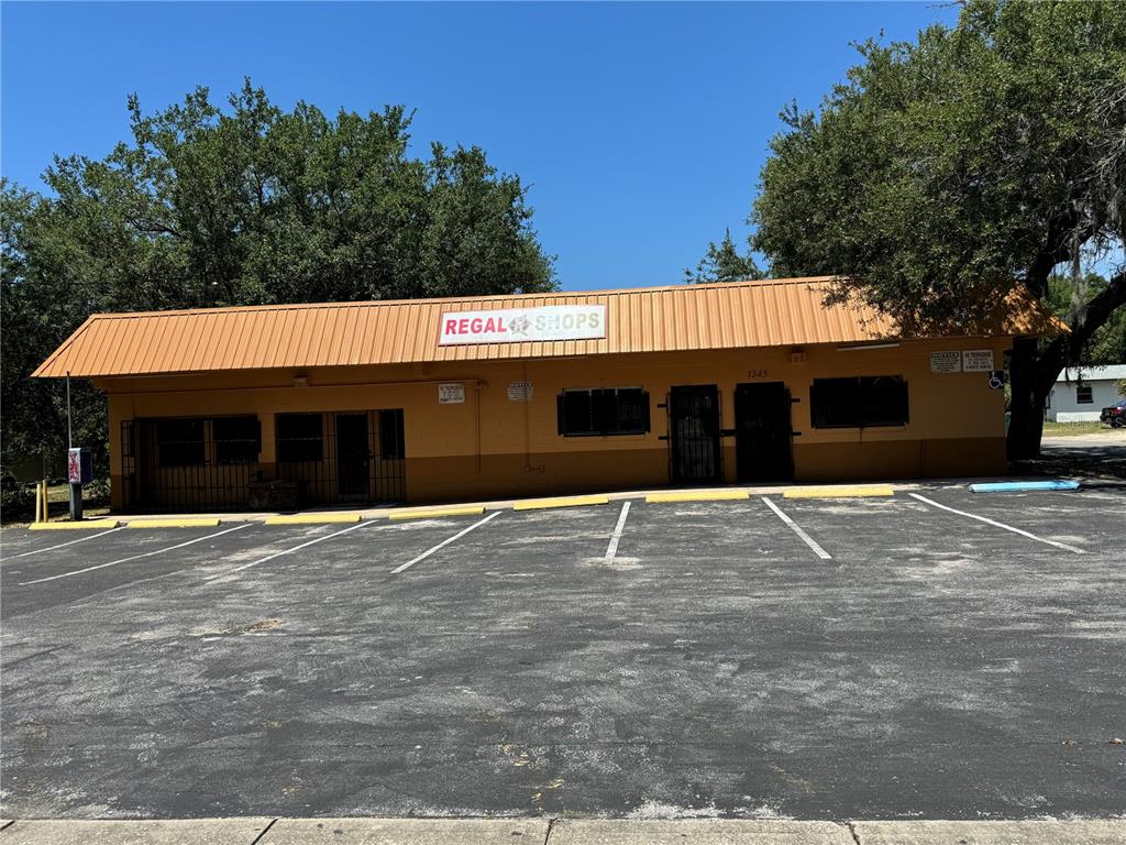 a front view of a building with trees