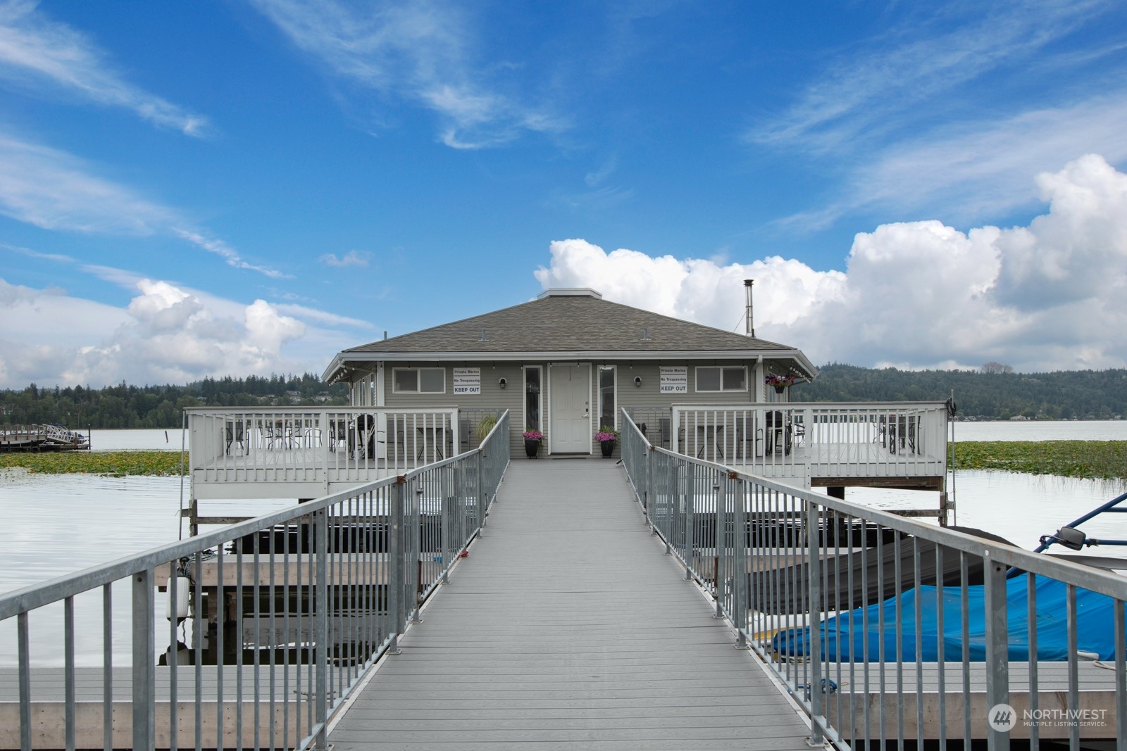 a view of a house with swimming pool and sitting area