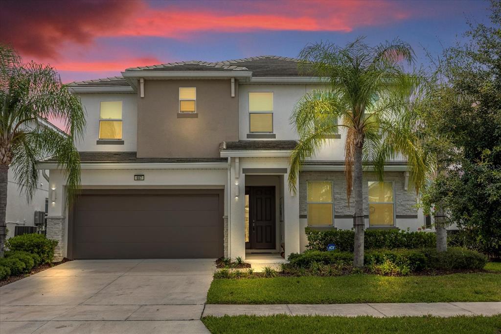 a front view of a house with a yard and garage