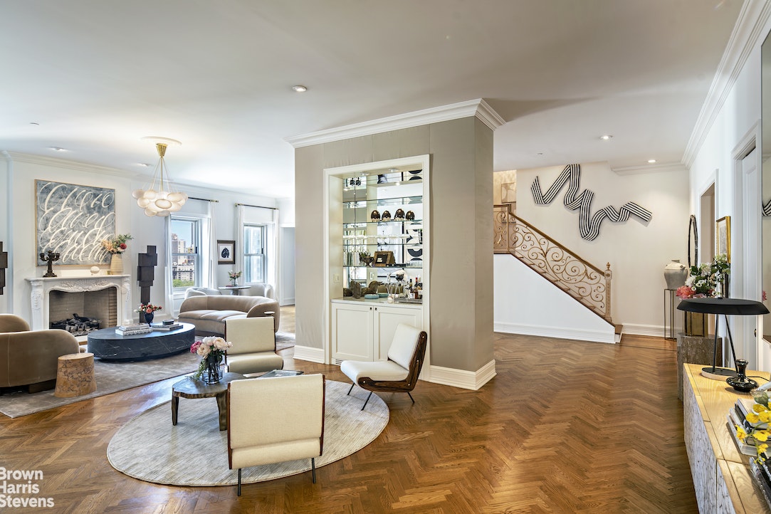 a living room with furniture and a dining table