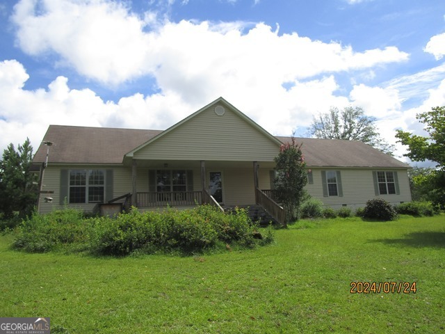 a front view of house with yard and green space