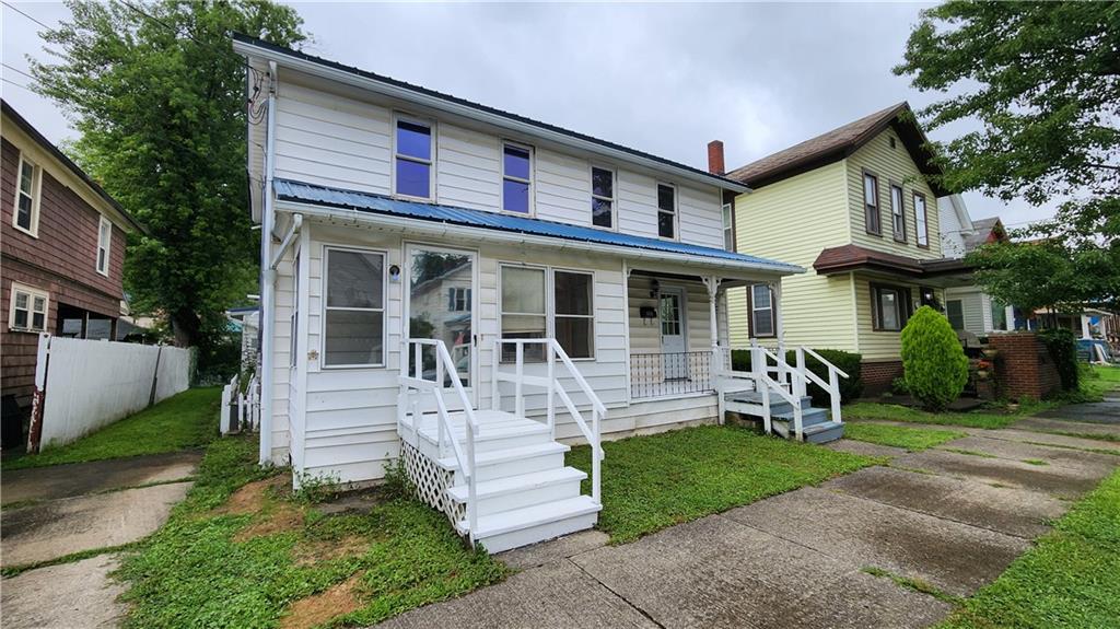 a front view of a house with a yard table and chairs