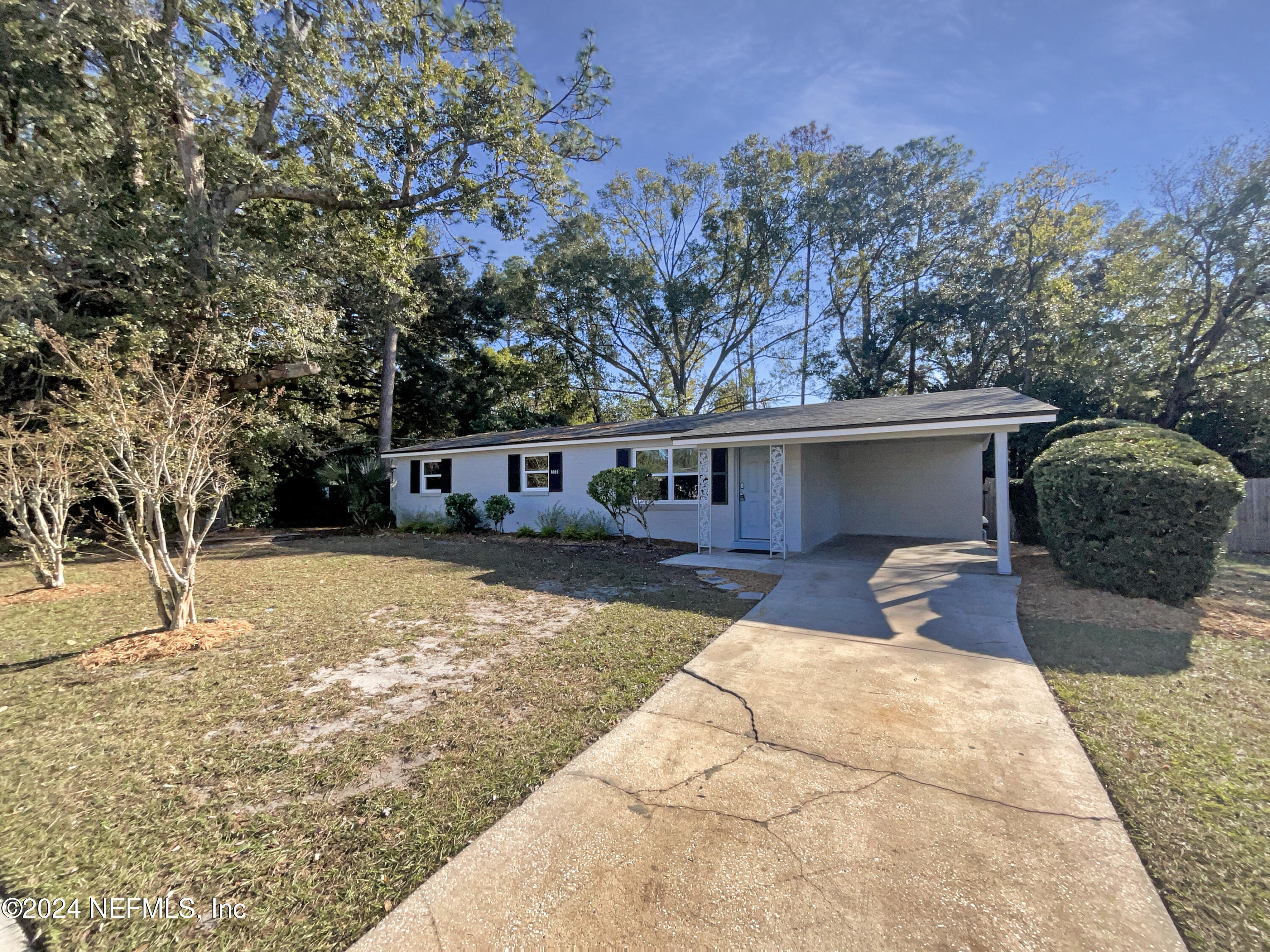 a front view of a house with a yard and a garage