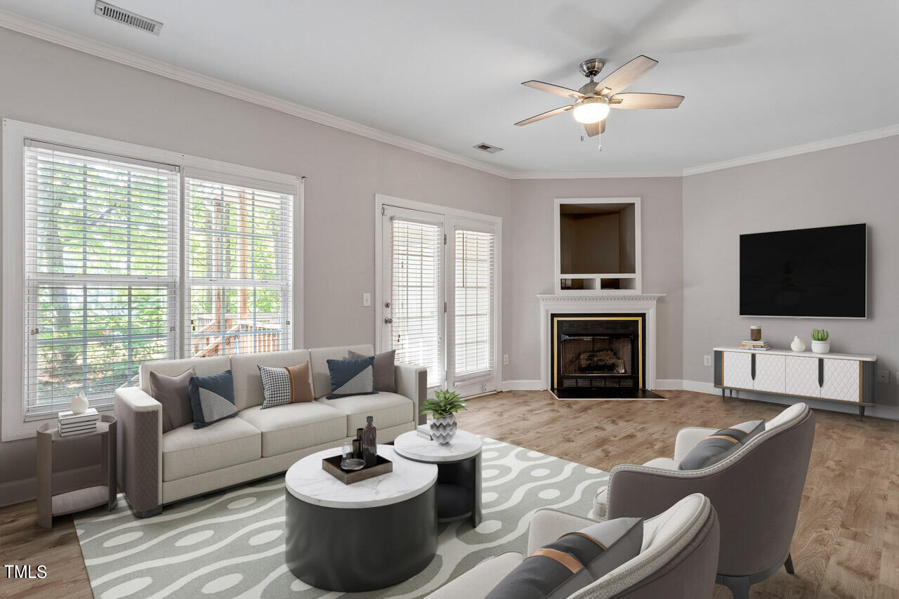 a living room with furniture a fireplace and a flat screen tv