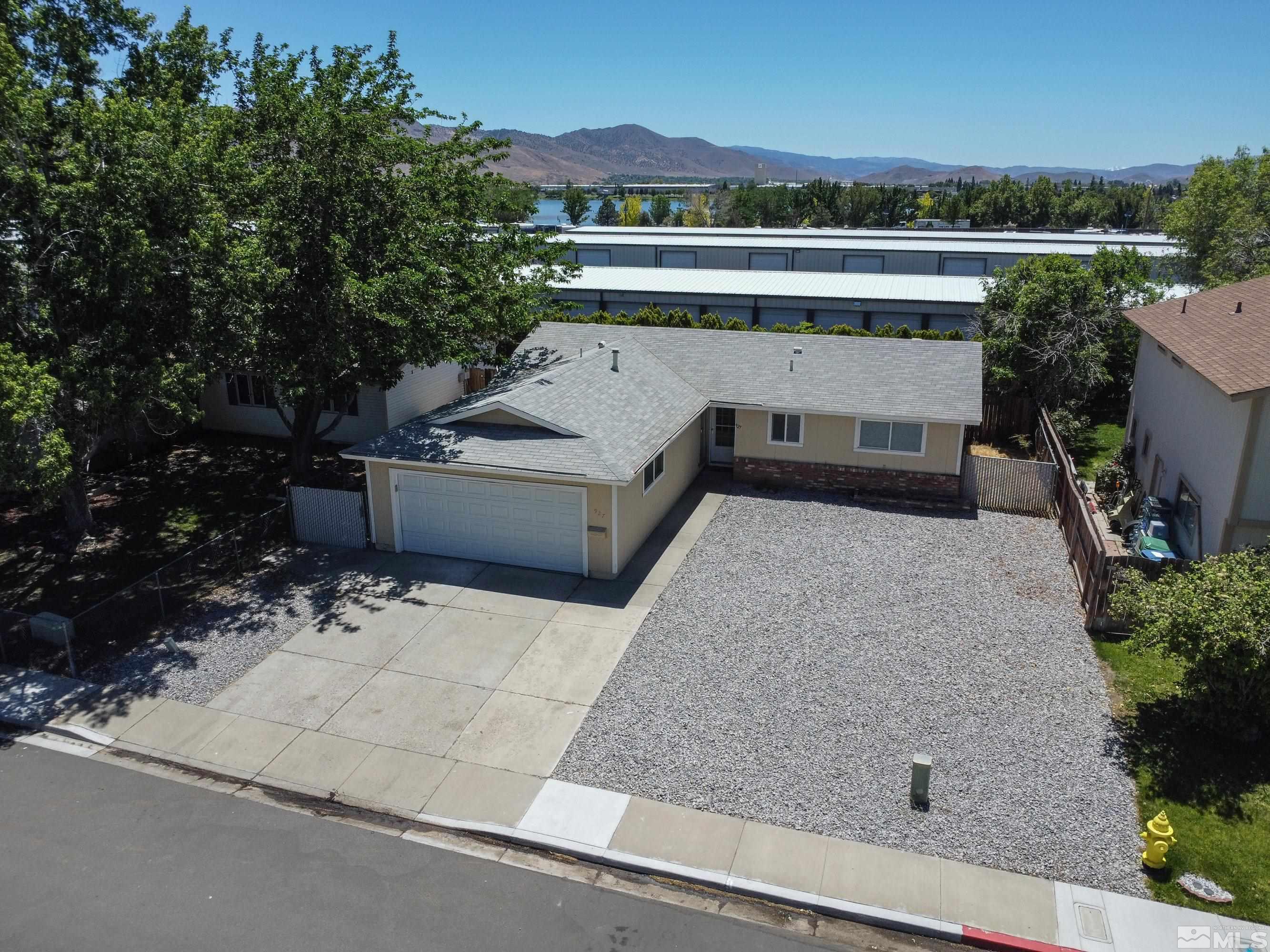 an aerial view of a house with a yard and sitting area