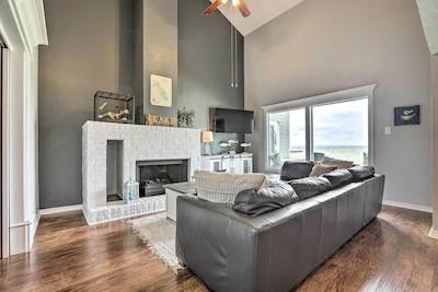 a living room with furniture a fireplace and a large window