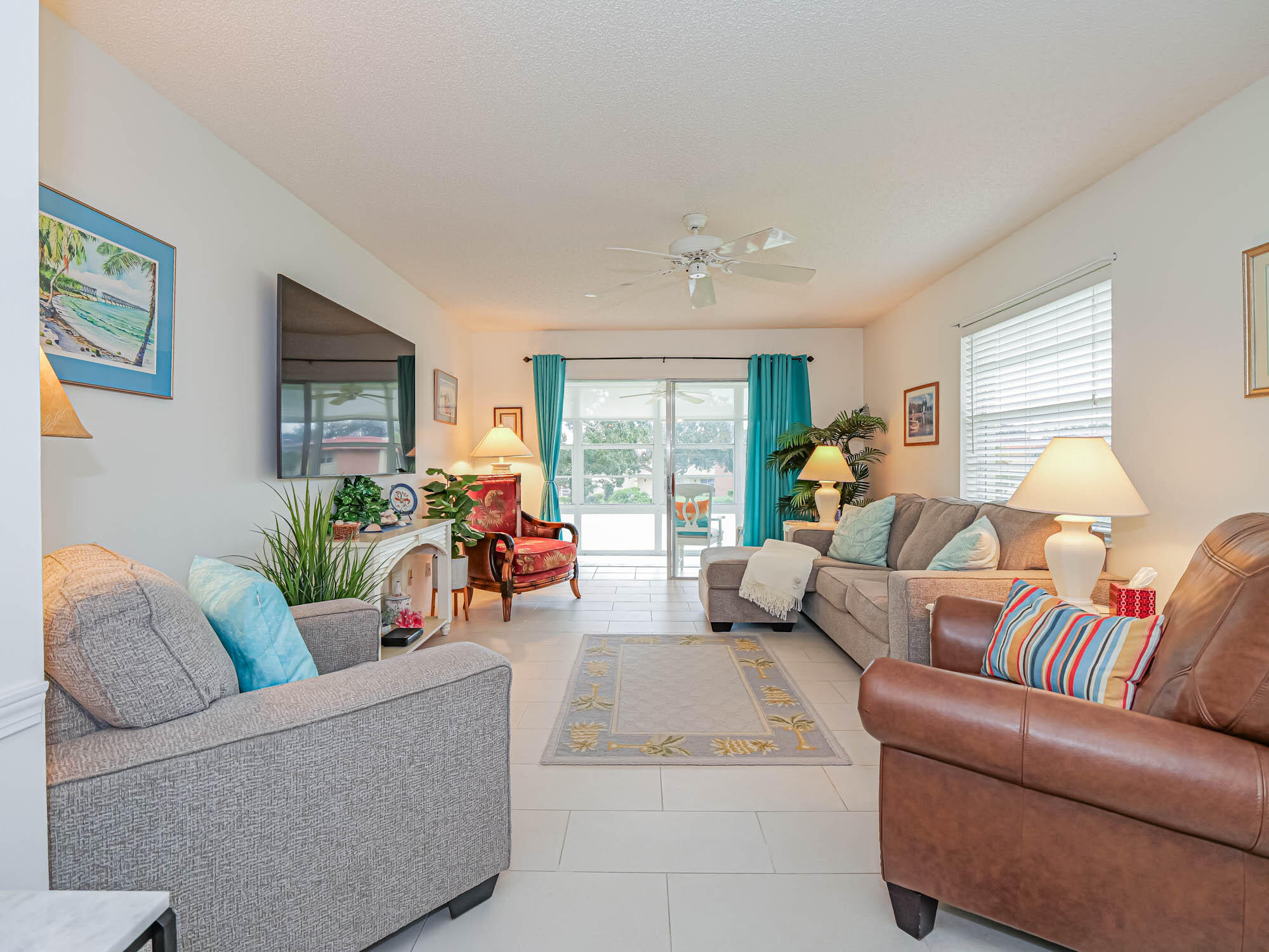 a living room with furniture and floor to ceiling window