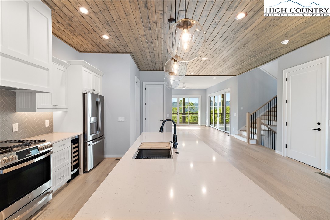 a kitchen with stainless steel appliances a stove sink and refrigerator