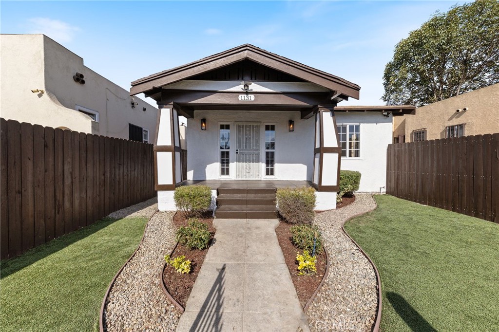 a view of a porch with furniture and wooden fence