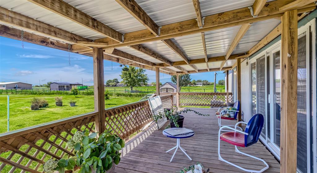 a view of porch with furniture and garden