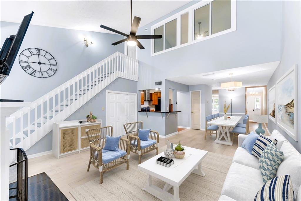 a living room with furniture and a chandelier