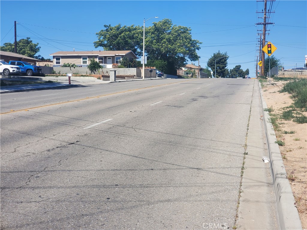 a front view of a house with a yard and a car parked on the road