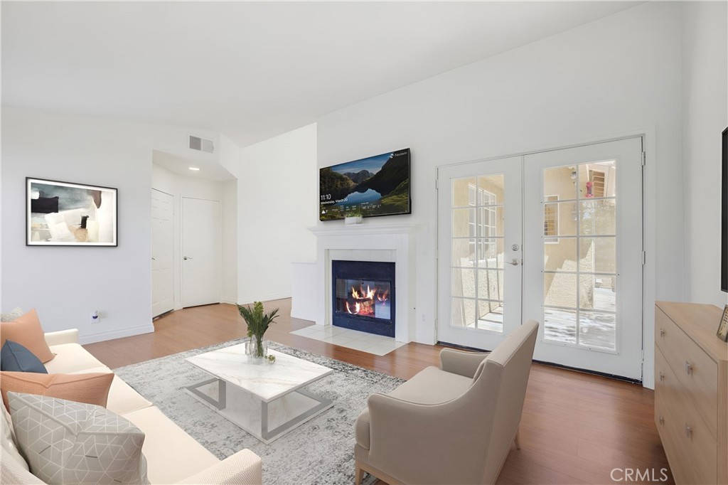 a living room with furniture a fireplace and a flat screen tv