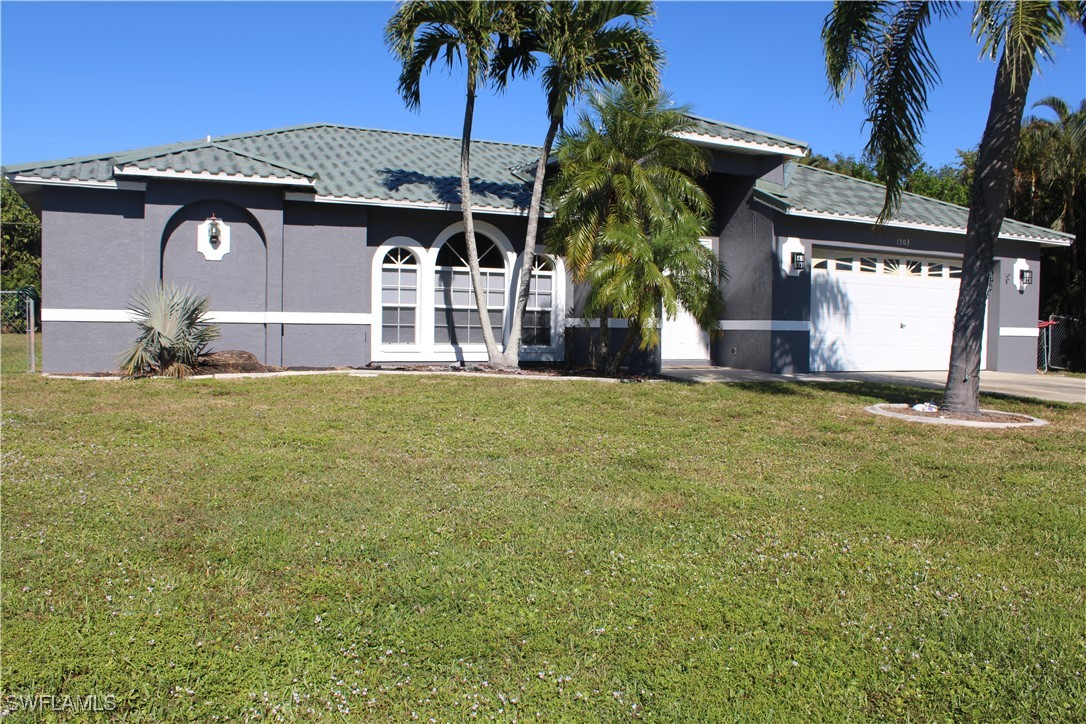 a view of a house with a yard