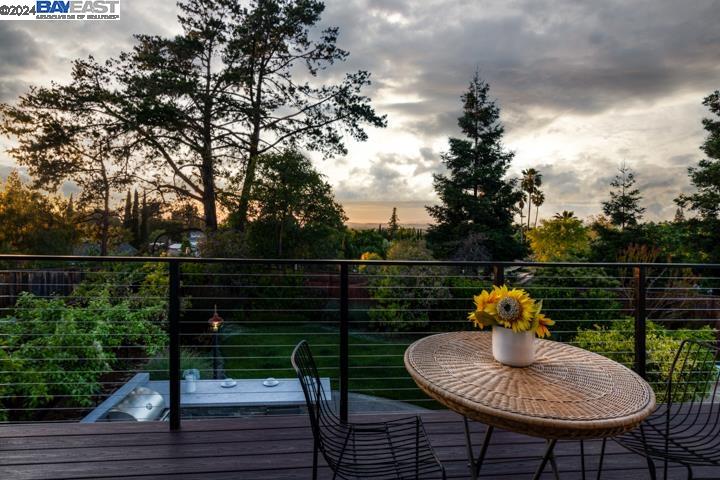 a view of a chairs and table on the wooden deck