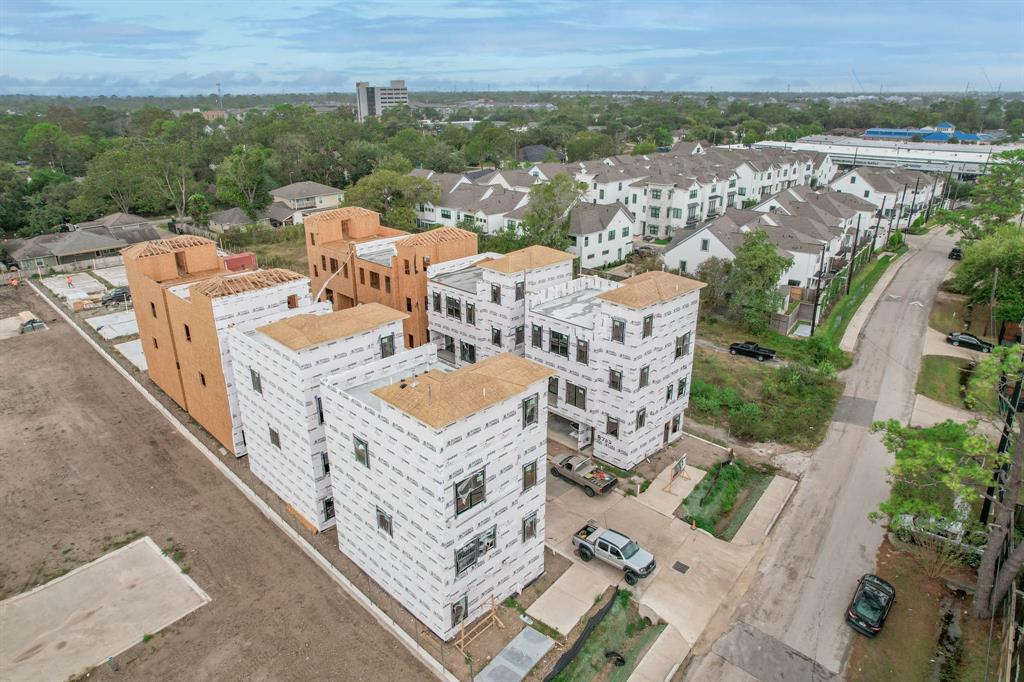 an aerial view of a house with balcony and trees al around