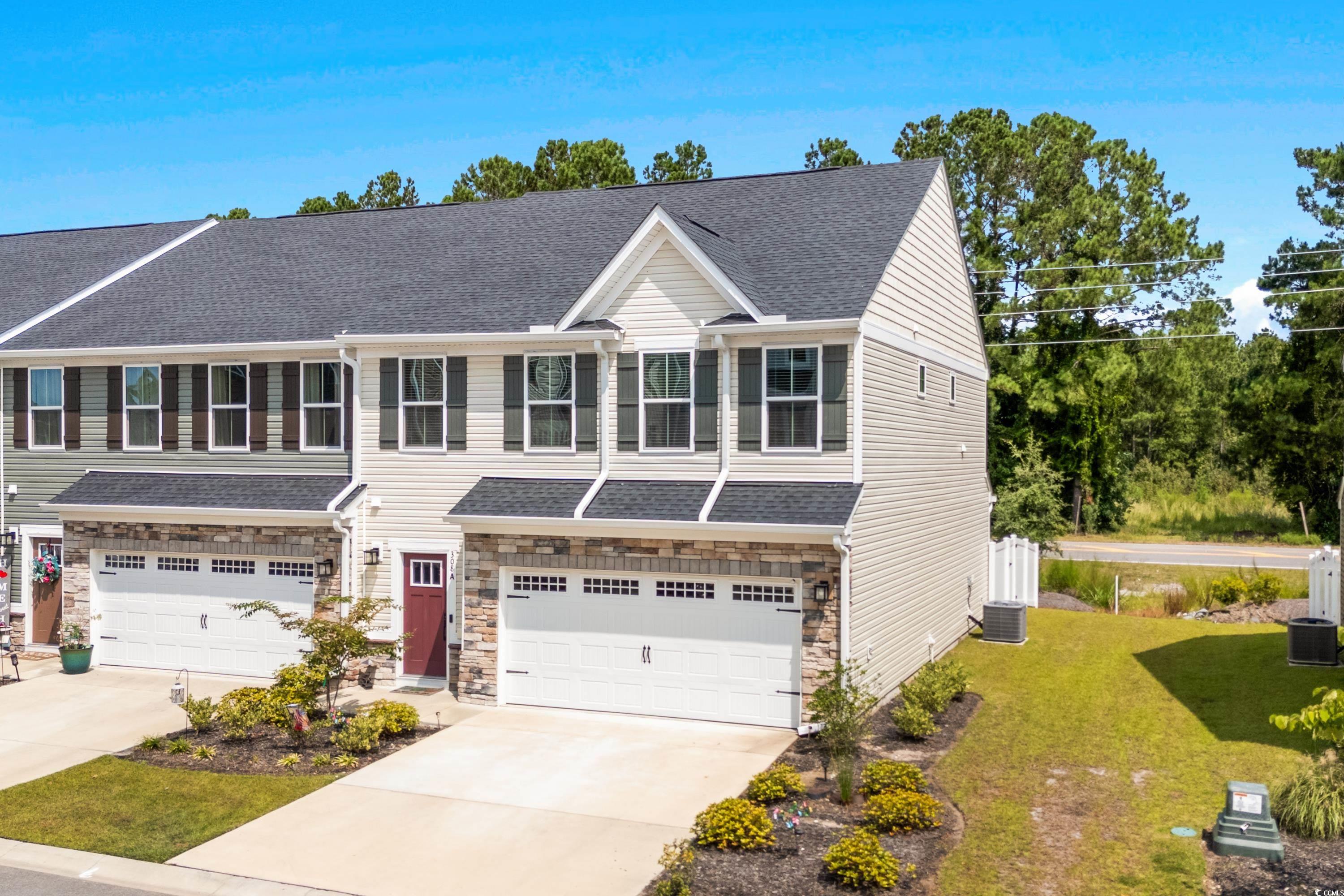 View of front of property featuring a garage, a fr