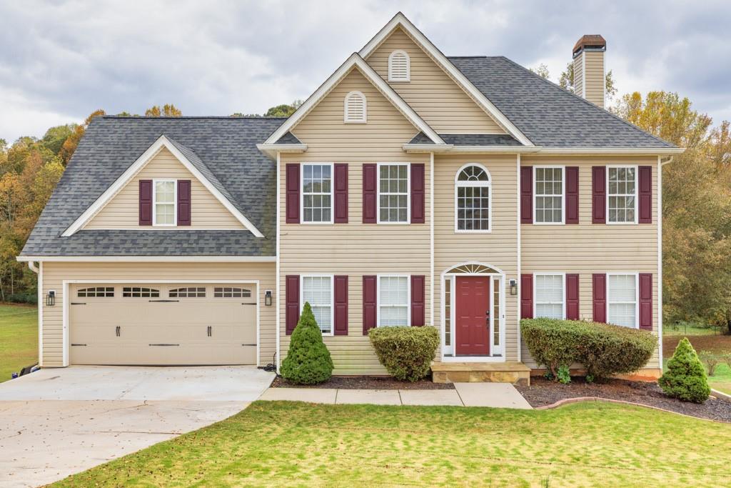 a front view of a house with a yard and garage