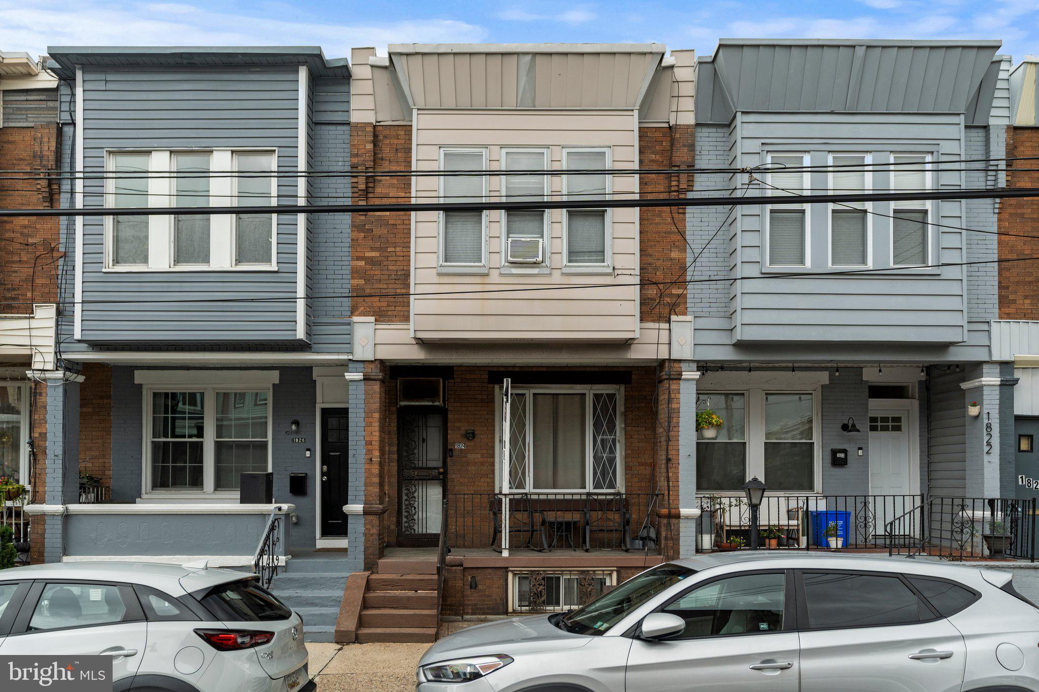 a front view of a house with cars parked