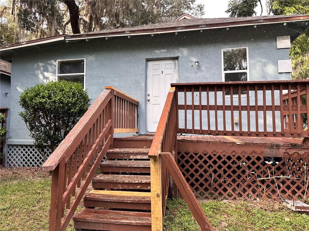 a view of a house with wooden fence