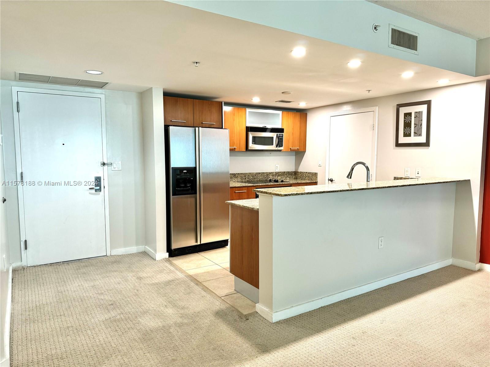 a kitchen with stainless steel appliances granite countertop a sink and cabinets