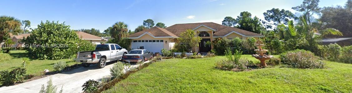 a front view of a house with a garden and a yard