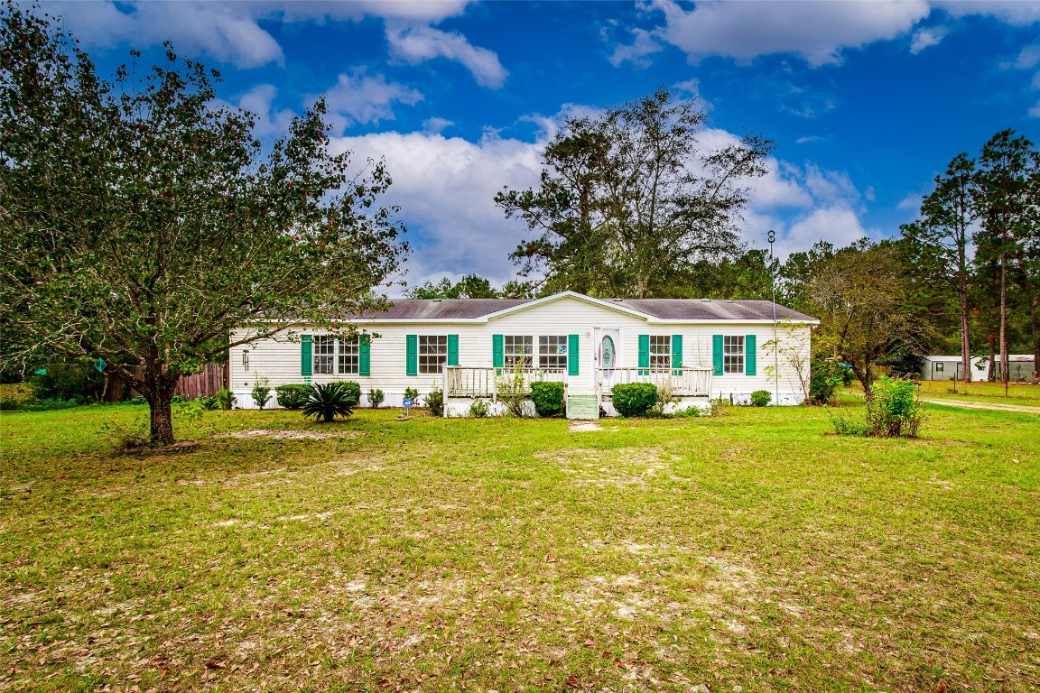 a front view of a house with a big yard