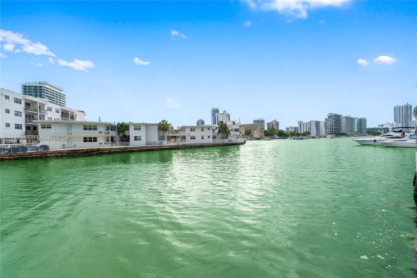 a view of a city with tall buildings and ocean view