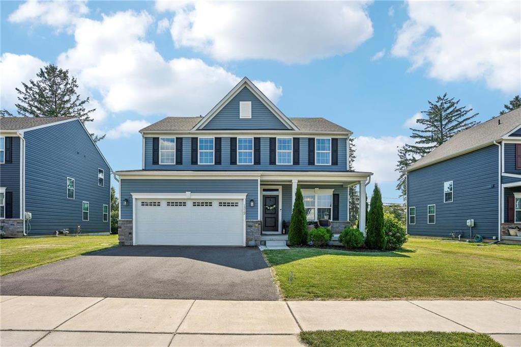 a front view of a house with a yard and garage