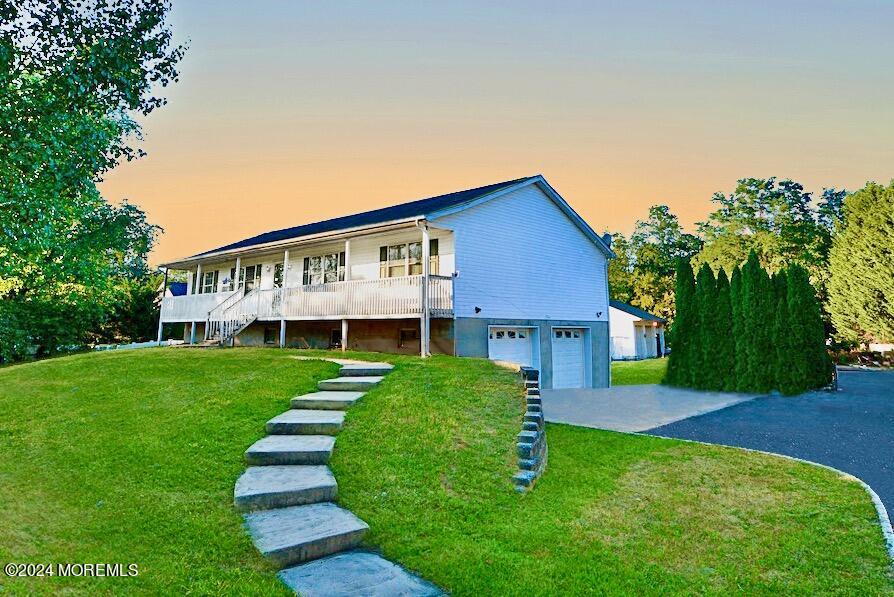 a view of house with backyard and garden